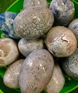 Green basket of clay eggs