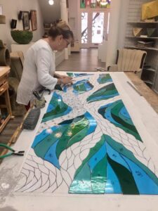 Michaele Rose working on stained glass for chapel