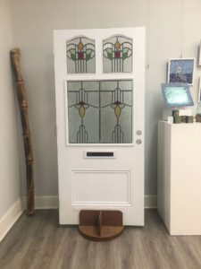 Tall off white door with stained glass inserts