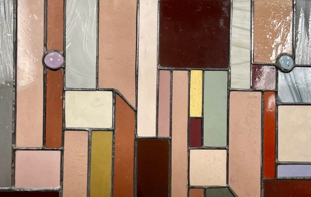 Closeup of rectangle glass pieces in different colors with jewel accents