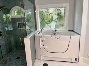 final installation of stained glass privacy window over bath tub