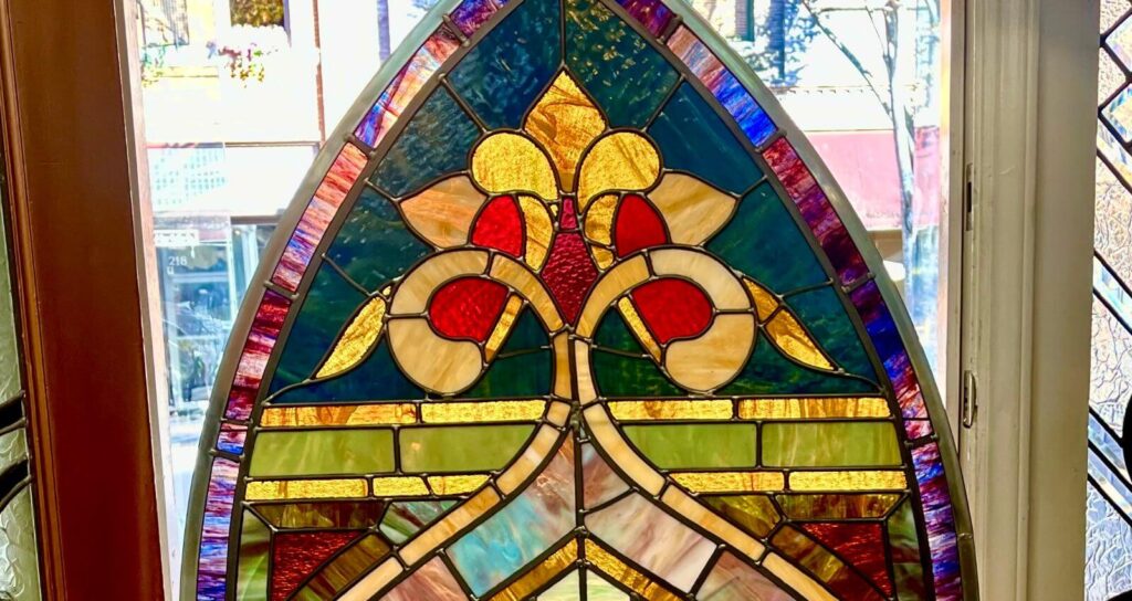 cropped photo of top portion of stained glass church panel