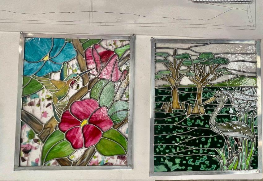 Two colorful nature-inspired stained glass windows