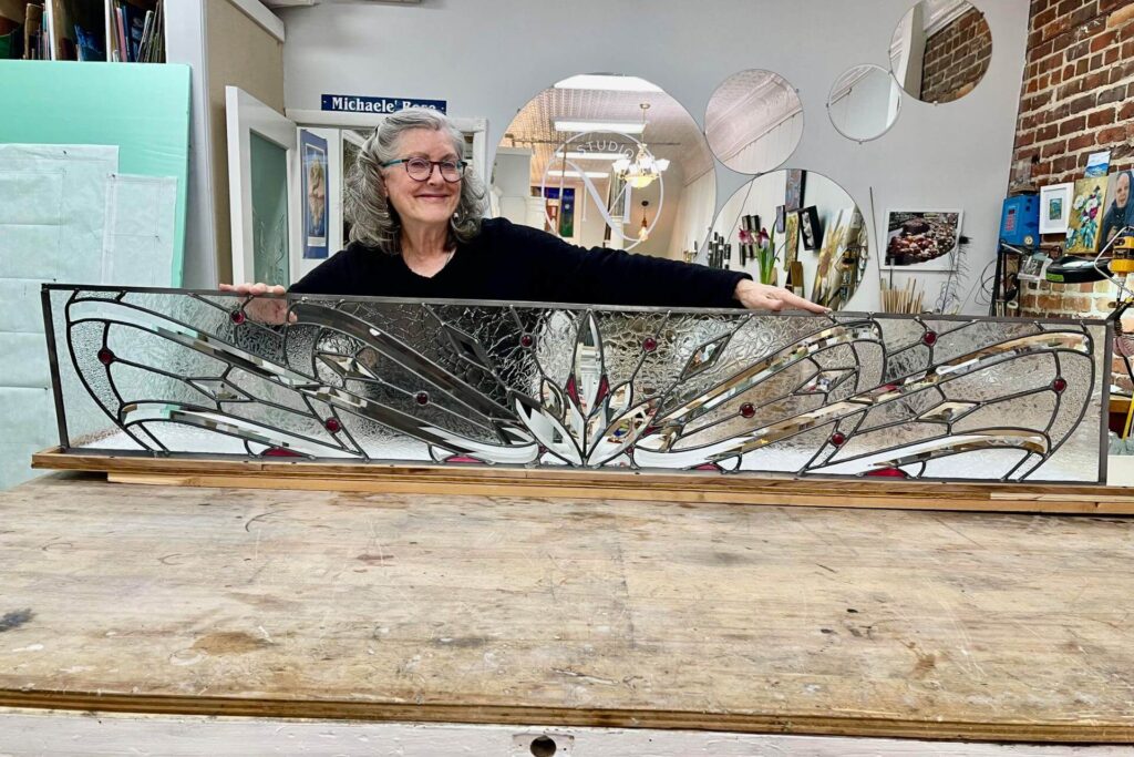 Woman holding a vertical custom glass transom